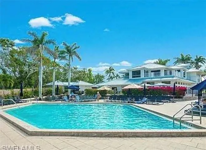 Community pool featuring a patio