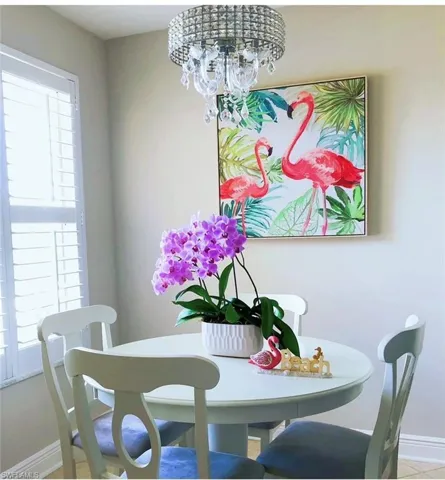 Dining area featuring baseboards and a chandelier
