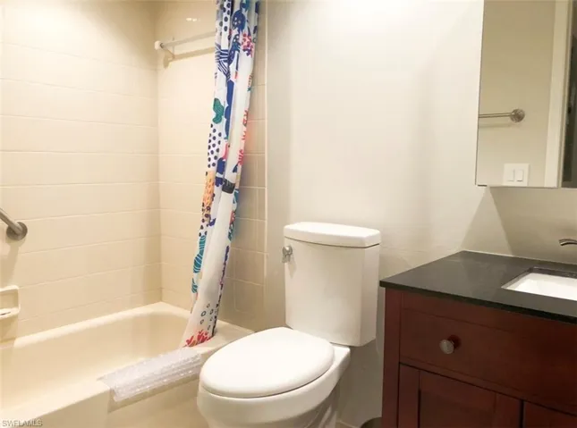 Full bath with vanity and shower / bath combo with shower curtain