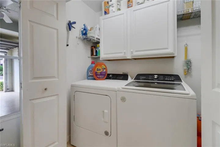 Laundry room featuring cabinet space and separate washer and dryer
