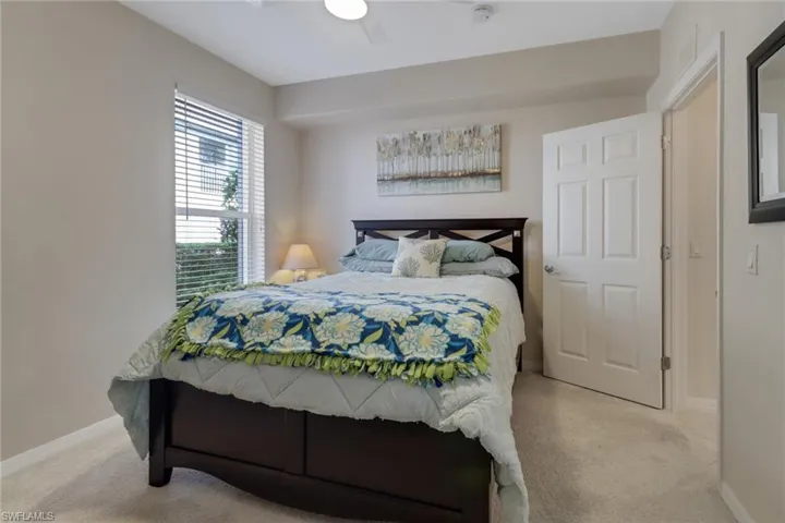 Bedroom with light colored carpet and ceiling fan