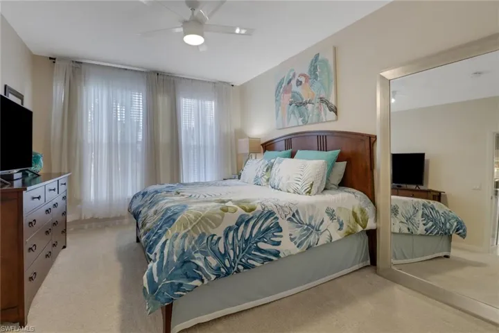 Bedroom featuring light carpet and ceiling fan