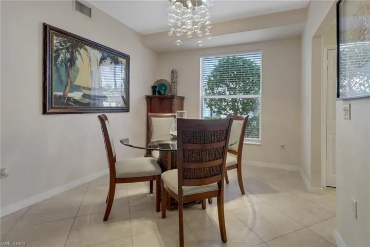 Dining area featuring hanging lights and light tile patterned floors