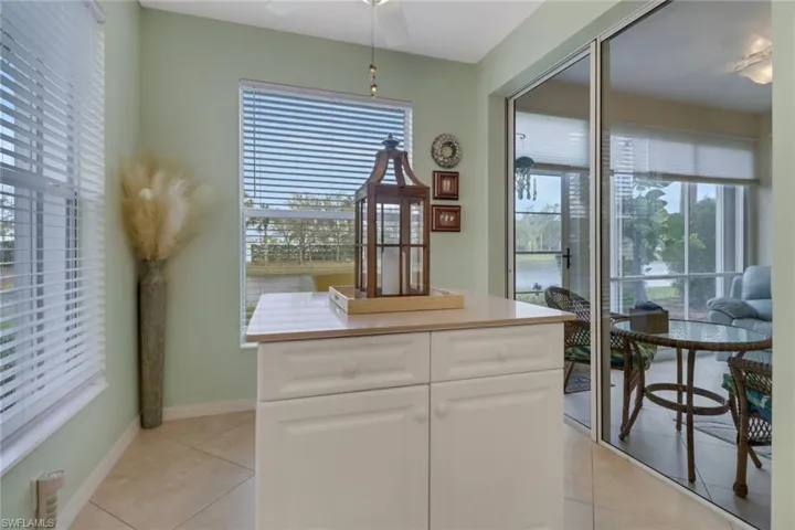 Kitchen with a center island, light tile patterned floors, and light countertops