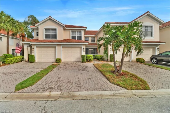 Mediterranean / spanish house with decorative driveway, stucco siding, and a tiled roof