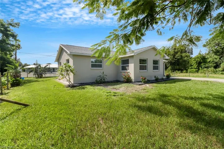 Back of house featuring a yard
