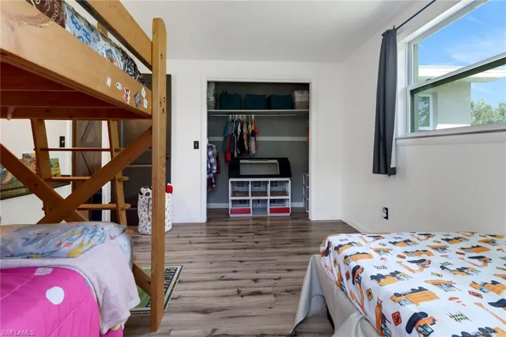 Bedroom featuring dark hardwood / wood-style floors and a closet