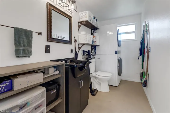Bathroom with vanity, toilet, and concrete floors