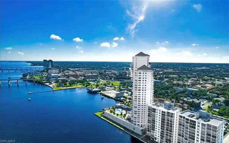 View of urban area featuring a large body of water and a notable bridge