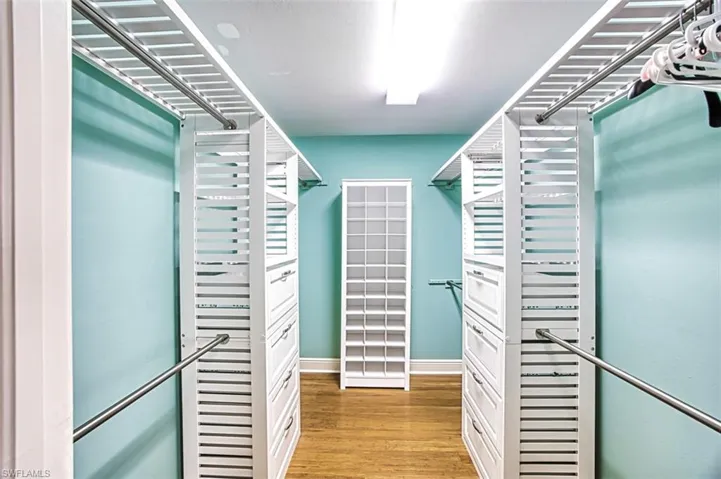 Walk in closet featuring light wood-style floors
