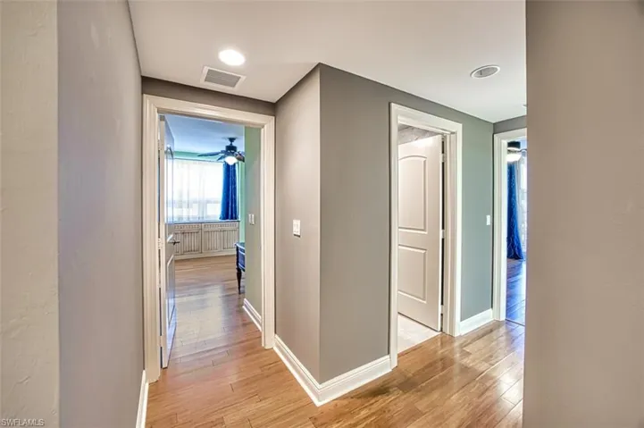 Hallway with baseboards and light wood-type flooring