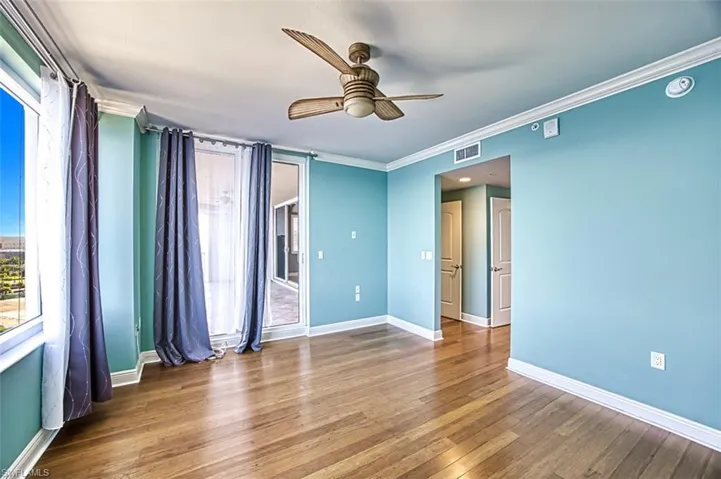 Unfurnished room featuring ornamental molding, wood-type flooring, and ceiling fan