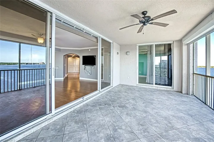 Unfurnished sunroom with arched walkways