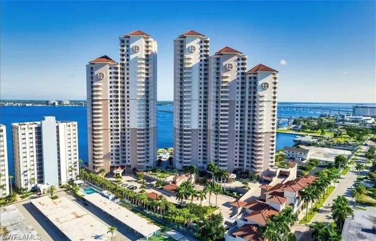 View of building exterior with a water view and a view of city
