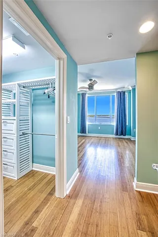 Hallway with light wood finished floors and baseboards
