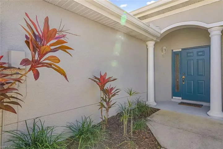 lovely landscaping and a blue door welcome you