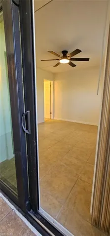Spare room featuring light tile patterned floors and a ceiling fan