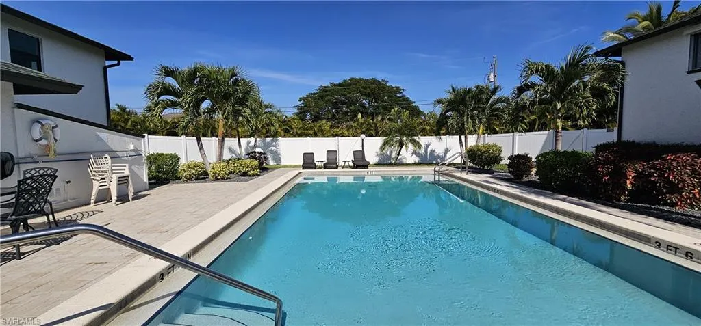 View of swimming pool with a patio and a fenced backyard