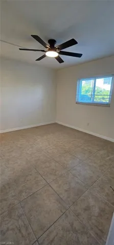 Guest room featuring baseboards and a ceiling fan