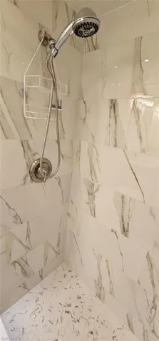 Bathroom view of a marble finish shower