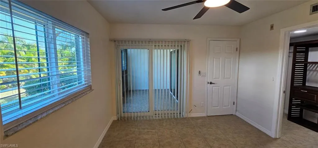 Owners Suite with a ceiling fan and light tile patterned floors