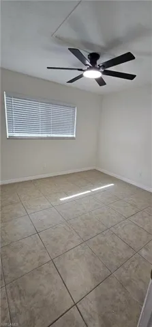 Guest room featuring a ceiling fan and light tile patterned flooring