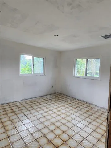 Unfurnished room with plenty of natural light