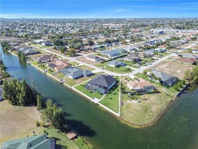 Aerial view of residential area featuring a nearby body of water