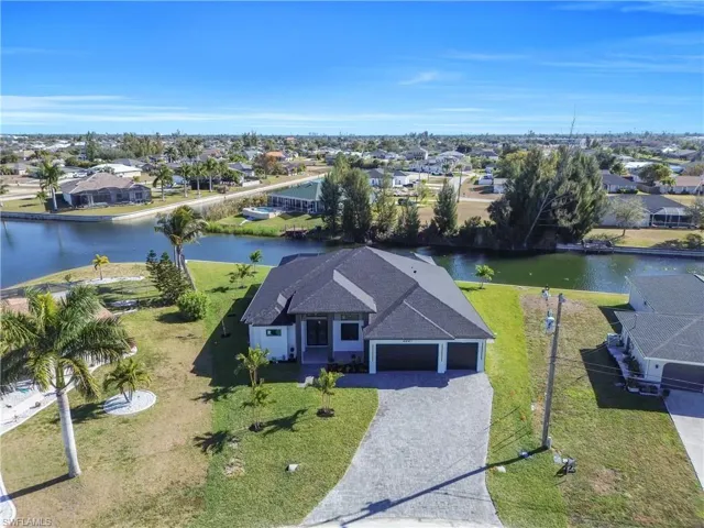 Aerial perspective of suburban area featuring a nearby body of water