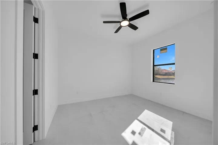 Spare room featuring light marble finish flooring and ceiling fan