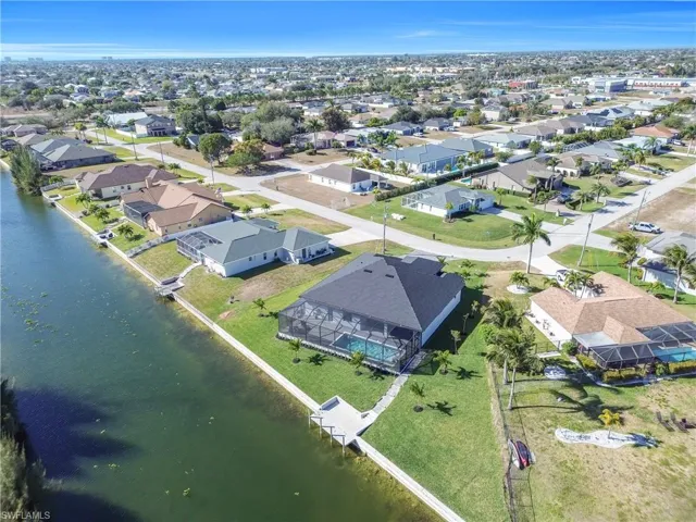 Aerial perspective of suburban area with a large body of water