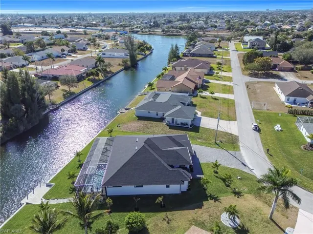 Aerial perspective of suburban area with a nearby body of water