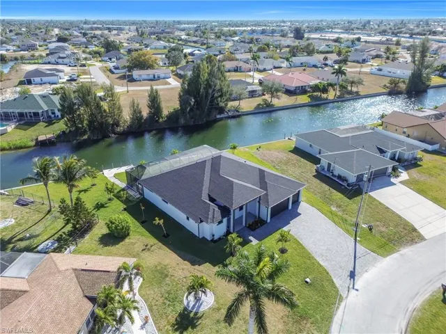 Aerial view of residential area featuring a nearby body of water