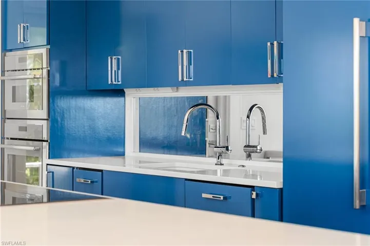Beautifully updated kitchen with custom blue cabinetry and quartz countertops.