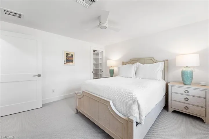 Spacious guest bedroom with natural light and coastal charm.