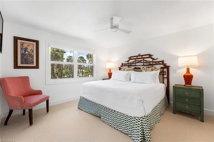 Spacious guest bedroom with natural light and coastal charm.