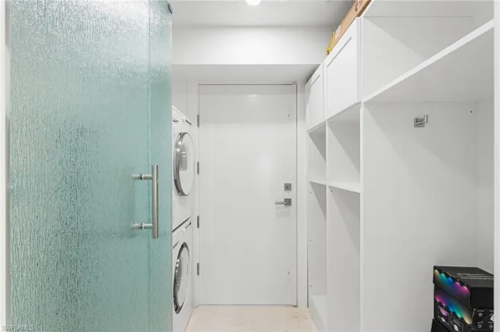Additional bathroom with a stackable washer/ dryer
