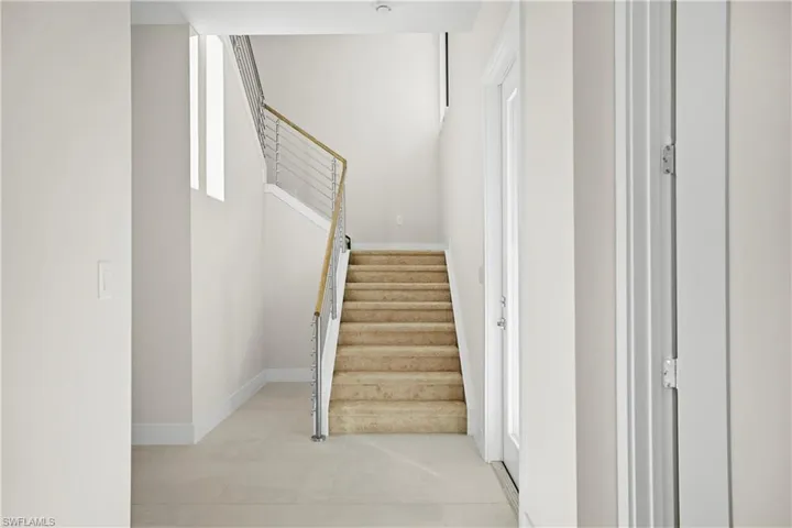 Entry foyer featuring contemporary cable-railed staircase