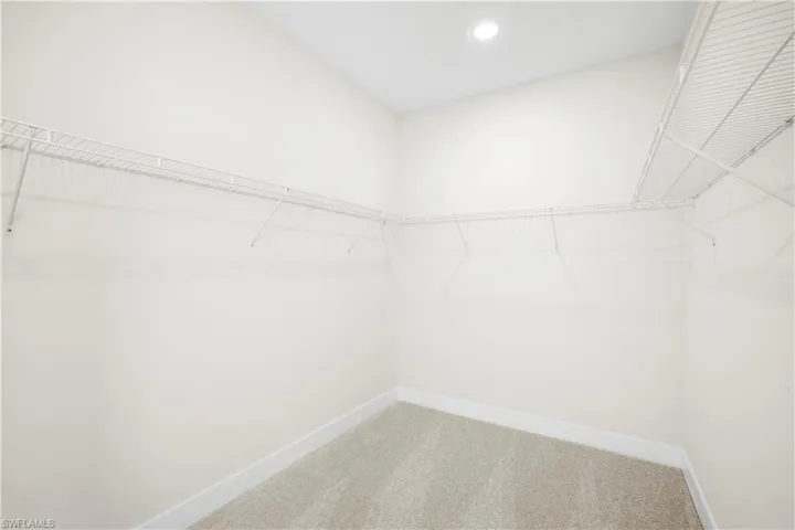 Jack-and-Jill bedroom with recessed lighting and neutral finishes