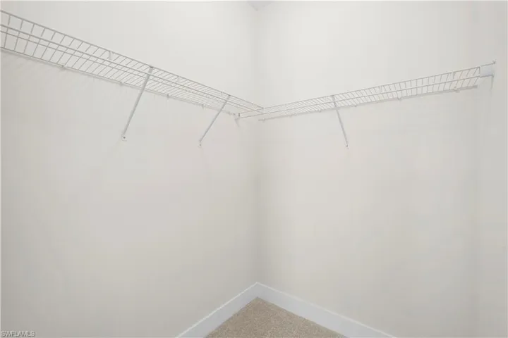 Jack-and-Jill bathroom with dual vanities, glass-enclosed shower, and tile flooring