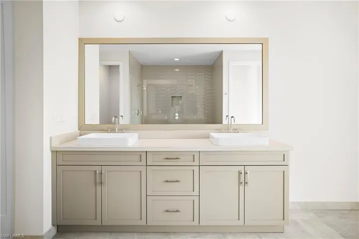 Primary bathroom with dual vanities and refined finishes