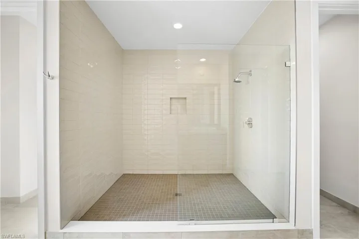 Primary bathroom featuring dual private water closets and walk-in shower