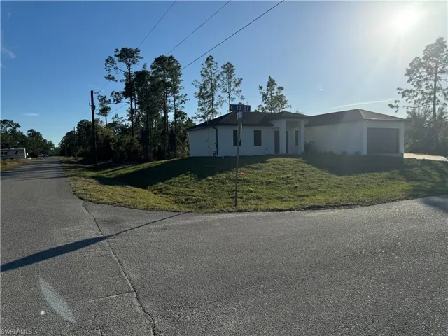View of front of house featuring a garage and a front yard