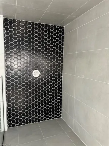 Bathroom featuring walk in shower and tile patterned floors