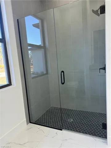 Bathroom with a shower with shower door