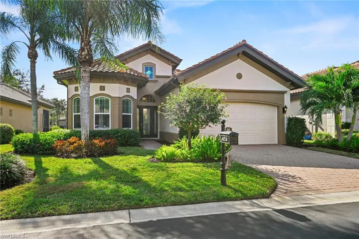 Mediterranean / spanish house featuring decorative driveway, a front lawn, stucco siding, and a garage
