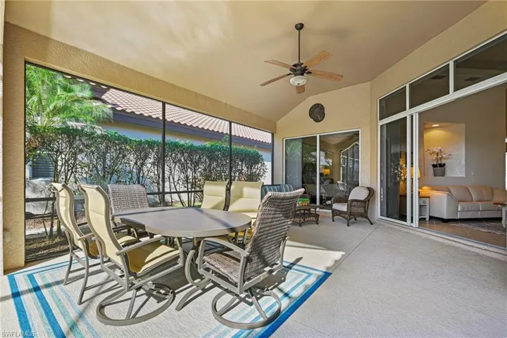 View of patio / terrace featuring outdoor dining area, a ceiling fan, and a sunroom
