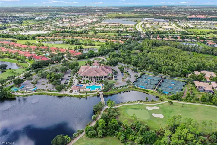 Aerial view of property's location with a nearby body of water and a golf course