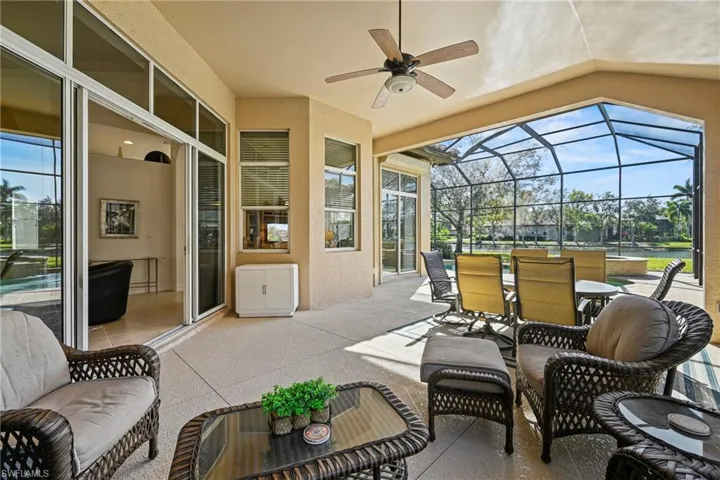 View of patio featuring a sunroom, a ceiling fan, a lanai, and outdoor dining area
