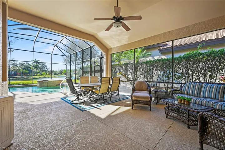 Sunroom / solarium featuring a patio, lofted ceiling, a ceiling fan, an outdoor living space, and a jacuzzi